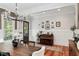 Elegant dining room with hardwood floors, piano and stylish chandelier at 1878 Headquarters Plantation Dr, Johns Island, SC 29455