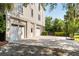 Exterior with a large driveway, a basketball hoop, and a three car garage, offering ample parking and storage at 1878 Headquarters Plantation Dr, Johns Island, SC 29455