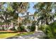 Charming two-story home with a traditional design, featuring a large driveway and mature trees at 1878 Headquarters Plantation Dr, Johns Island, SC 29455