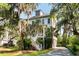 Stunning two-story home with a welcoming porch, staircase and lush landscaping, offering exceptional curb appeal at 1878 Headquarters Plantation Dr, Johns Island, SC 29455