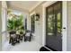 Inviting front porch with cozy seating, lantern lighting, and a stylish entryway showcasing a welcoming atmosphere at 1878 Headquarters Plantation Dr, Johns Island, SC 29455