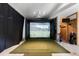 Golf simulator room featuring a projector screen, artificial turf, and a golf bag at 1878 Headquarters Plantation Dr, Johns Island, SC 29455