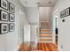 Well-lit hallway with hardwood floors and classic wall decor at 1878 Headquarters Plantation Dr, Johns Island, SC 29455