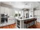 Bright kitchen featuring white cabinets, stainless appliances, and hardwood floors at 1878 Headquarters Plantation Dr, Johns Island, SC 29455
