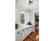 Bright kitchen featuring white cabinets, countertops, and hardwood floors at 1878 Headquarters Plantation Dr, Johns Island, SC 29455