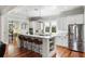 Bright, modern kitchen with a large island, stainless steel appliances, white cabinets and beautiful hardwood floors at 1878 Headquarters Plantation Dr, Johns Island, SC 29455
