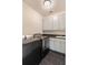 Well-equipped laundry room featuring modern appliances, sleek cabinetry, and dark countertops, maximizing efficiency at 1878 Headquarters Plantation Dr, Johns Island, SC 29455