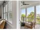 Inviting porch with views, ceiling fan, shutters, and a comfortable seating arrangement at 1878 Headquarters Plantation Dr, Johns Island, SC 29455