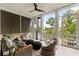 Relaxing screened porch with comfortable seating, a ceiling fan, spiral staircase, and serene outdoor views at 1878 Headquarters Plantation Dr, Johns Island, SC 29455