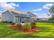Large fenced backyard with a patio area, green grass and well-manicured garden beds with mulch at 202 Buttercup Ln, Summerville, SC 29486