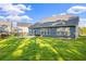 The home's spacious backyard features green grass and a patio perfect for entertaining at 202 Buttercup Ln, Summerville, SC 29486