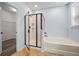 Modern bathroom featuring a walk-in shower, soaking tub, and tile flooring at 202 Buttercup Ln, Summerville, SC 29486