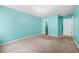 Bedroom with teal walls, carpeted floors, and an adjacent walk-in closet at 202 Buttercup Ln, Summerville, SC 29486