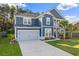 Charming two-story home with blue siding, a well-manicured lawn, and a two-car garage at 202 Buttercup Ln, Summerville, SC 29486