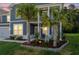 Lovely landscaped front yard showcasing palm trees and decorative stonework at 202 Buttercup Ln, Summerville, SC 29486