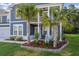 Inviting front yard featuring palm trees and well-maintained landscaping adds curb appeal to this beautiful home at 202 Buttercup Ln, Summerville, SC 29486