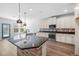 Kitchen island with sink and granite countertop plus designer pendant lights at 202 Buttercup Ln, Summerville, SC 29486