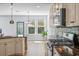 Well-lit kitchen features granite countertops, stainless steel appliances and wood flooring at 202 Buttercup Ln, Summerville, SC 29486