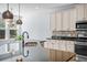 Modern kitchen with granite counters, stainless appliances and stylish pendant lights at 202 Buttercup Ln, Summerville, SC 29486