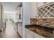 Bright kitchen features granite counters, stainless steel appliances and tile backsplash at 202 Buttercup Ln, Summerville, SC 29486