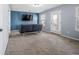 Living room with blue accent wall, mounted TV, and view to exterior deck at 202 Buttercup Ln, Summerville, SC 29486