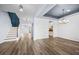 Open-concept living room with stylish hardwood floors, modern lighting, and a staircase at 202 Buttercup Ln, Summerville, SC 29486