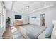 Staged bedroom featuring hardwood floors, tray ceilings, furniture, and an ensuite bathroom at 202 Buttercup Ln, Summerville, SC 29486