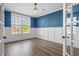 Bright office with blue accent wall, white wainscoting, and wood-look flooring at 202 Buttercup Ln, Summerville, SC 29486