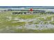 Breathtaking aerial view of waterfront homes nestled in a serene marshland setting at 202 Mariners Cay Dr, Folly Beach, SC 29439