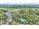 Aerial view showcasing community amenities including a pool, tennis courts, and marsh views at 202 Mariners Cay Dr, Folly Beach, SC 29439