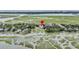 Charming aerial view of community featuring mature landscaping and waterfront access at 202 Mariners Cay Dr, Folly Beach, SC 29439