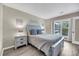 The bedroom features a comfortable queen bed with luxury linens and views from a large window at 202 Mariners Cay Dr, Folly Beach, SC 29439