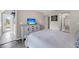 This bedroom features a TV, ample dresser space and a serene view of the ensuite bathroom at 202 Mariners Cay Dr, Folly Beach, SC 29439