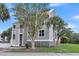 Coastal condo building featuring a metal roof, gray siding, and palm trees at 202 Mariners Cay Dr, Folly Beach, SC 29439