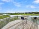 Scenic marsh view from a wooden deck, complete with a small table and chairs at 202 Mariners Cay Dr, Folly Beach, SC 29439