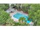 Aerial view of a community pool featuring lounge chairs, lush trees, and landscaping at 202 Mariners Cay Dr, Folly Beach, SC 29439
