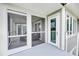 Exterior of the home shows an enclosed porch with an outdoor seating area at 202 Mariners Cay Dr, Folly Beach, SC 29439
