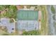 Aerial view of two tennis courts surrounded by trees and greenery at 202 Mariners Cay Dr, Folly Beach, SC 29439