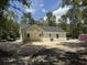 Exterior of home with covered back porch and door, nestled in a wooded lot at 216 Hill Dr, Summerville, SC 29483