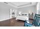 Bright and airy bedroom with hardwood floors and a rocking chair at 217 Quimby Hill Dr, Huger, SC 29450
