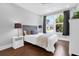 Bright bedroom with hardwood floors, a ceiling fan, and large window with neighborhood views at 217 Quimby Hill Dr, Huger, SC 29450