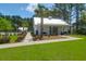 Charming single-story clubhouse featuring a white exterior, well-manicured lawn, and inviting entryway at 217 Quimby Hill Dr, Huger, SC 29450