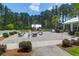 An outdoor community area features seating around a fire pit, nestled among trees and landscaping at 217 Quimby Hill Dr, Huger, SC 29450