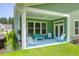 Relaxing covered back porch with a ceiling fan, neutral furniture and green outdoor carpet at 217 Quimby Hill Dr, Huger, SC 29450