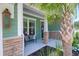 Inviting front porch with stone accents and a cozy bench seating area at 217 Quimby Hill Dr, Huger, SC 29450