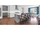 Modern kitchen boasts a central island with bar stools, stainless steel appliances, and ample counter space at 217 Quimby Hill Dr, Huger, SC 29450