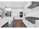 Bright kitchen featuring a large island, stainless steel appliances, and white cabinets with modern hardware at 217 Quimby Hill Dr, Huger, SC 29450
