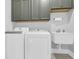 Bright laundry room with modern washer, dryer, and sink at 217 Quimby Hill Dr, Huger, SC 29450