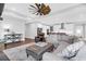 Inviting living room with hardwood floors, a ceiling fan, and an open layout leading to the kitchen at 217 Quimby Hill Dr, Huger, SC 29450
