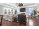 Open-concept living room featuring hardwood floors, a ceiling fan, fireplace, and lots of natural light at 217 Quimby Hill Dr, Huger, SC 29450